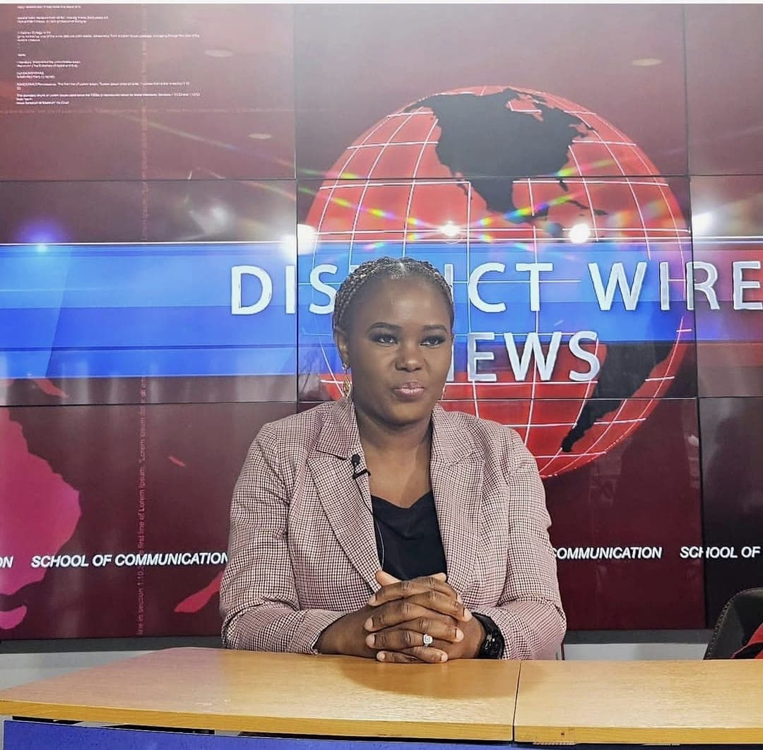 Tayo Ojewunmi-Ojo at a professional broadcast news desk